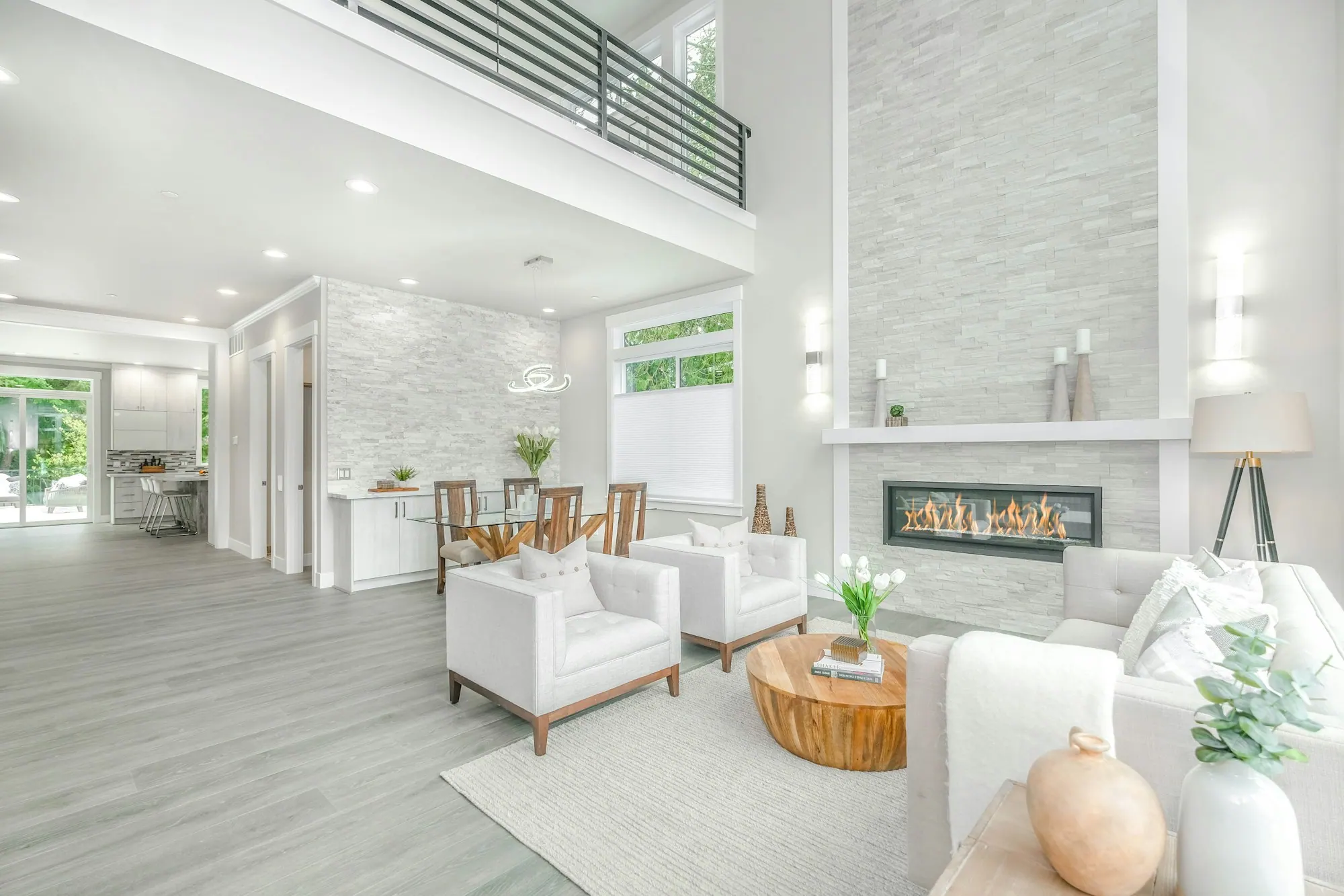 Double-height atrium living room in soft daylight